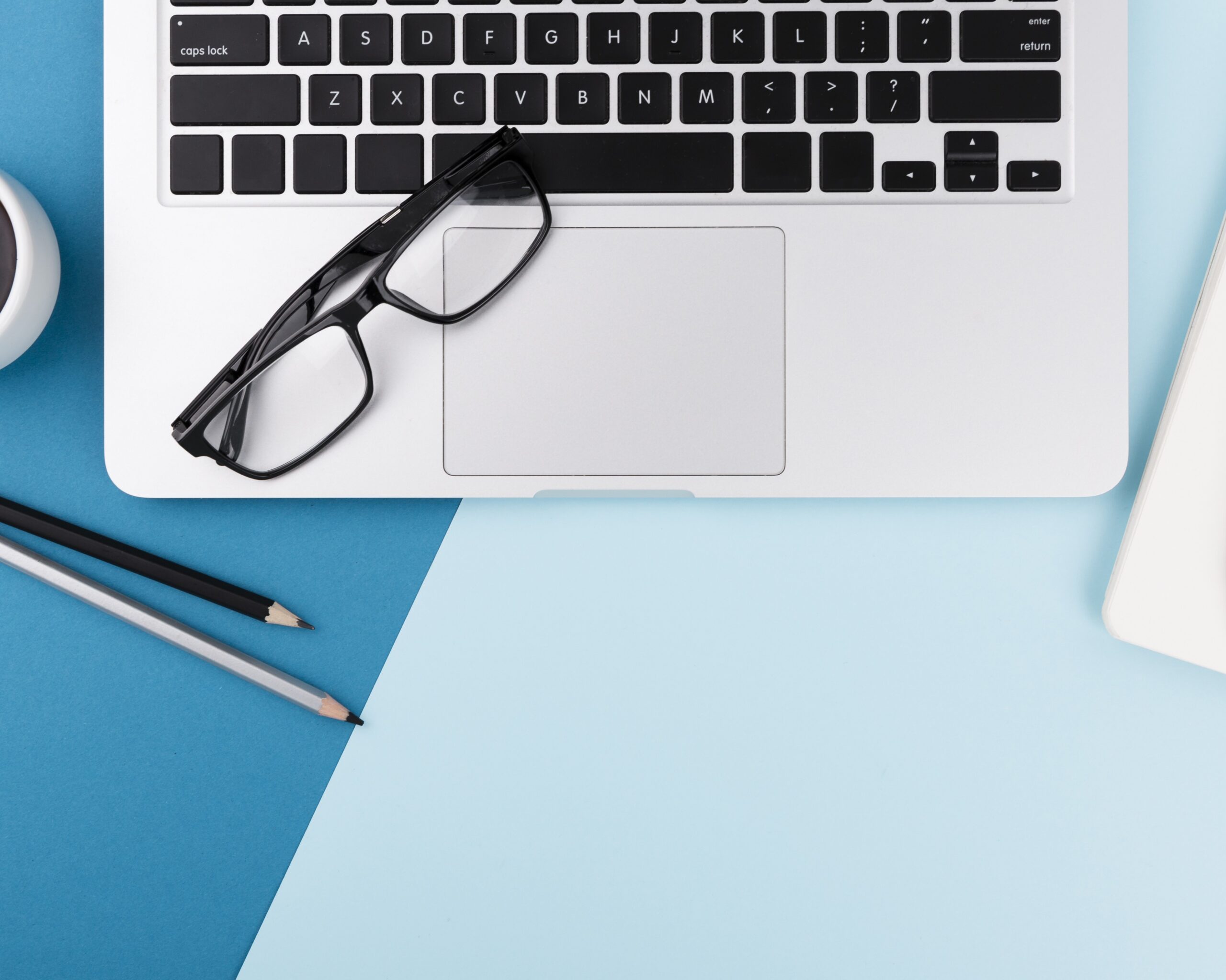 top-view-laptop-glasses-with-copy-space